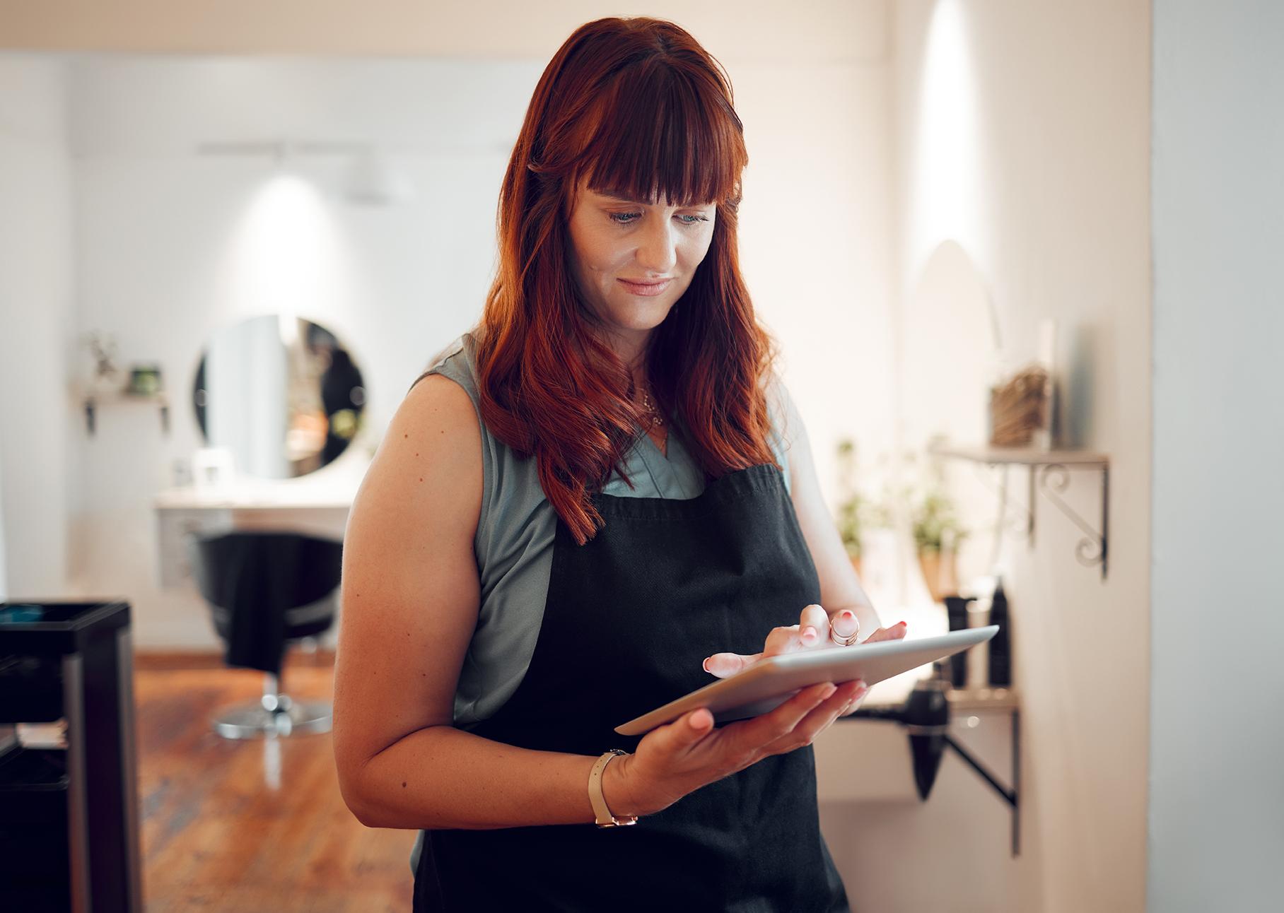 Image of a woman reading her tablet